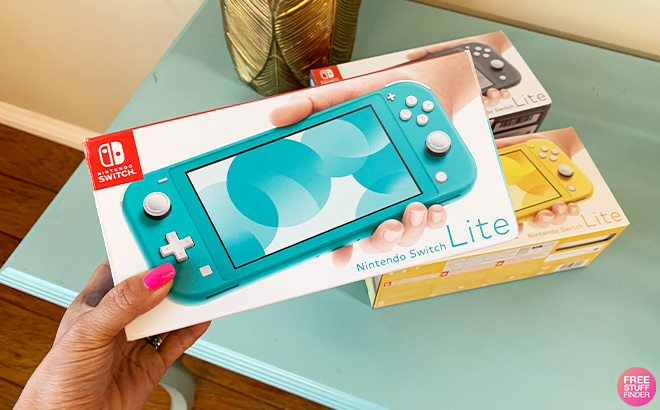 A Person Holding Nintendo Switch Lite in Turquoise Color
