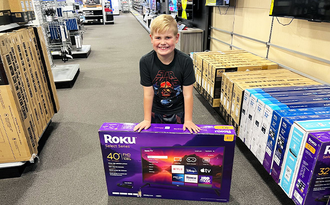 Boy and Roku Select 40 Inch Smart TV Inside a Best Buy Store