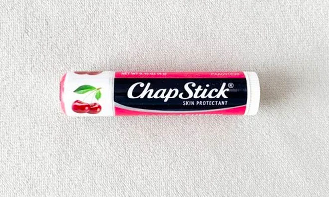 Chapstick Classic Cherry Lip Balm on top of the Towel