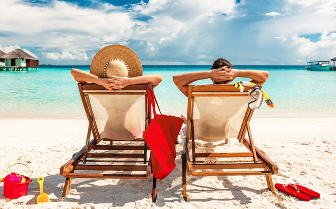 Couple on a Beach Relaxing in Lounging Chairs