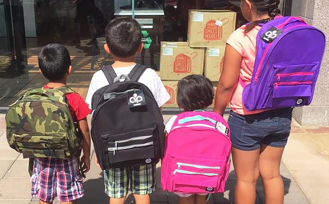 Four Kids Wearing Free Backpacks from Verizon