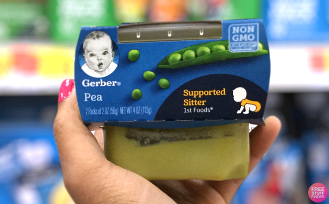 A Hand Holding Gerber Organic Baby Food in a Store Aisle