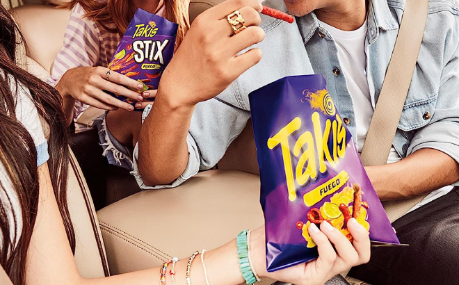 Group of Friends Enjoying Their Takis Fuego Rolled Spicy Tortilla Chips Group of Friends Enjoying Their Takis Fuego Rolled Spicy Tortilla Chips
