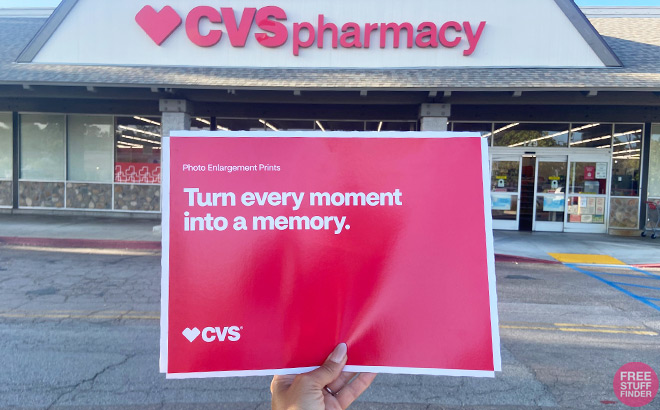 Hand Holding CVS Photo Prints in an Envelope in front of a CVS Store