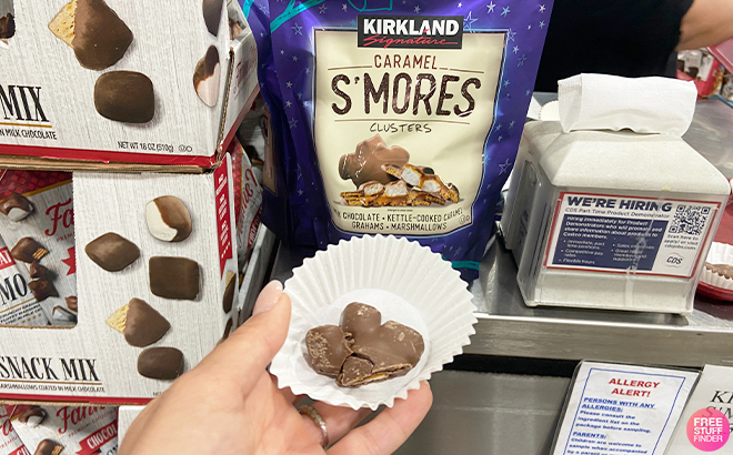 Hand Holding Kirkland Signature Caramel SMores Clusters Sample in Costco