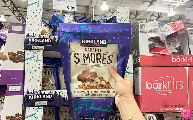 Hand Holding Kirkland Signature Caramel SMores Clusters in Costco