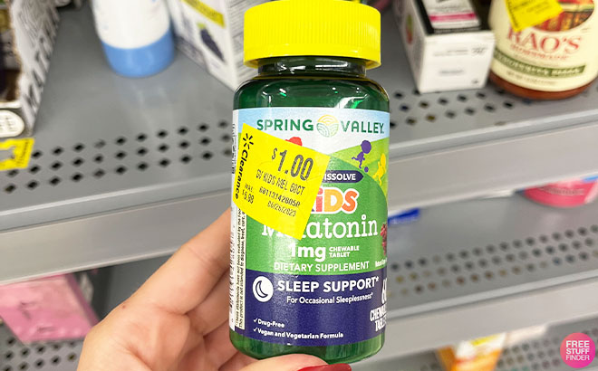 Hand Holding Spring Valley Kids Melatonin Gummies 60 Count Hand Holding Spring Valley Kids Melatonin Gummies 60 Count