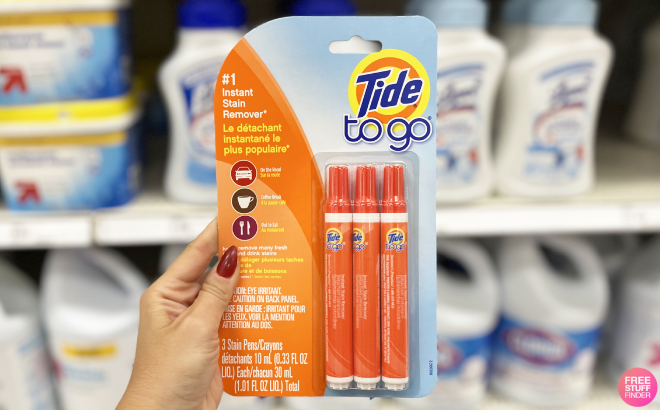 Hand Holding Tide to Go Instant Stain Remover Pen 3 Pack