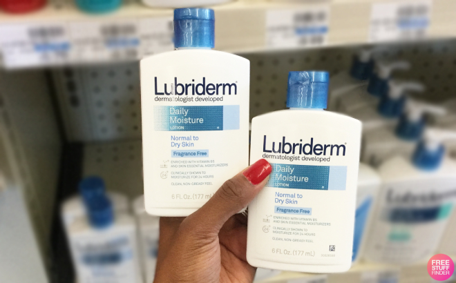Hand Holding Two Lubriderm Body Lotion