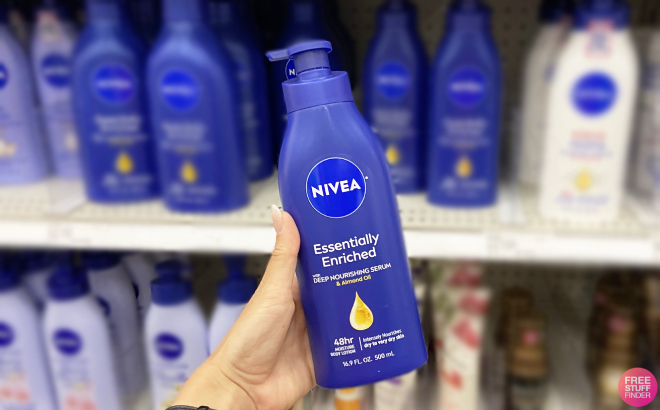 Hand Holding a Bottle of Nivea Essentially Enriched Body Lotion