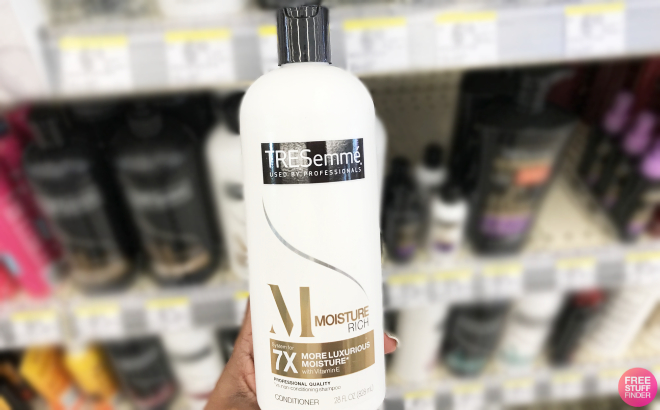 Hand Holding a Bottle of Tresemme Moisture Rich Conditioner