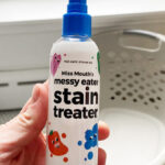 Hand Holding a Miss Mouths Messy Eater Stain Treater Spray