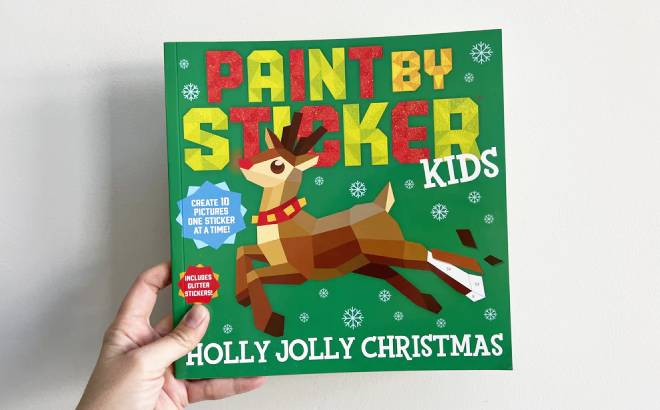 Hand Holding a Paint by Sticker Kids Holly Jolly Christmas Book