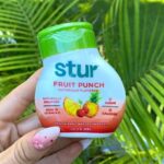 Hand Holding a Stur Fruit Punch Water Enhancer