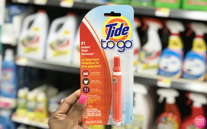 Hand Holding a Tide to Go Instant Stain Remover Pen