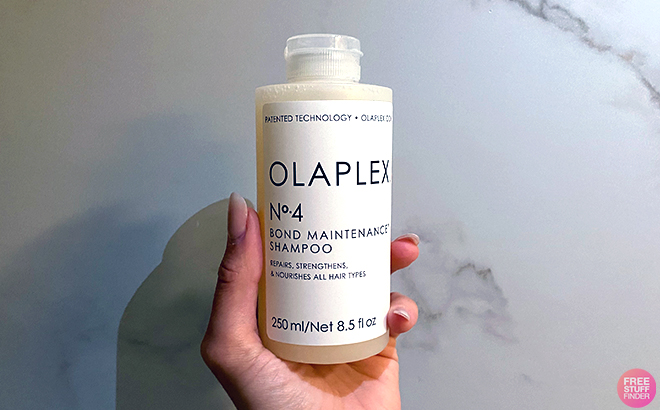 Hand holding Olaplex No 4 Bond Maintenance Shampoo