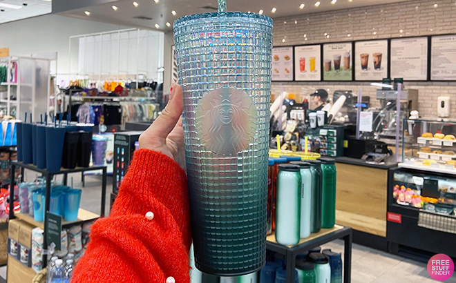 Hand holding one Starbucks Winter Studded Ombre 24 Ounce Tumbler