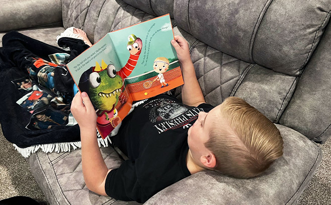 Kid Reading a Kids Book Laying on a Bed