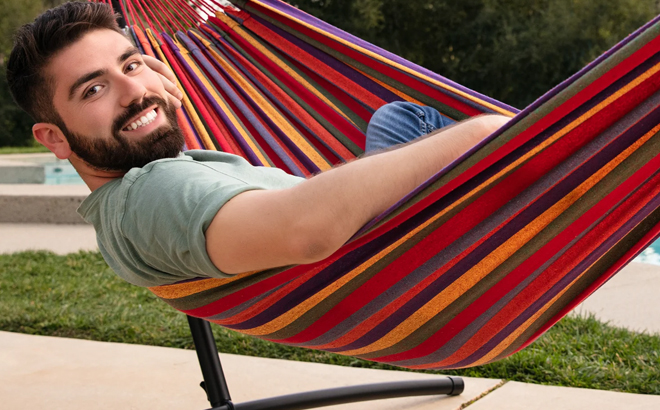 Man Sitting on a 2 Person Brazilian Style Double Hammock with Stand