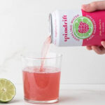 Spindrift Raspberry Lime Can Pouring in a Glass