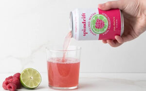 Spindrift Raspberry Lime Can Pouring in a Glass