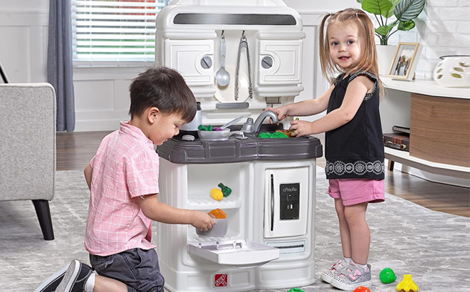 Two Kids Playing with Step2 Quaint Kitchen Set