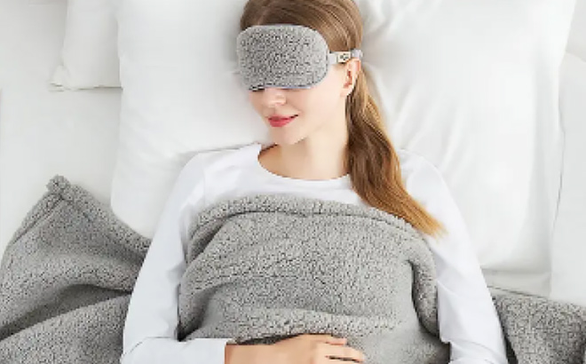 UGG Original Faux Shearling Throw Blanket Eye Mask Sleep Set on a Woman in Bed