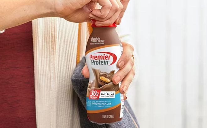 Woman Holding Premier Protein Shake Chocolate Peanut Butter