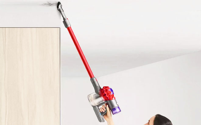 Woman Using Dyson V8 Origin Cordless Stick Vacuum