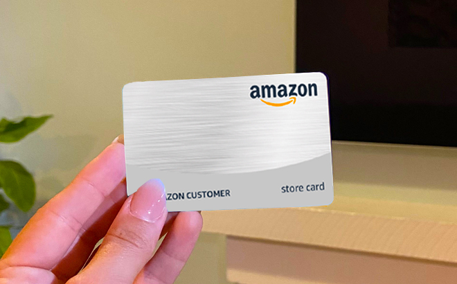 Woman hand holding the Amazon Store Card