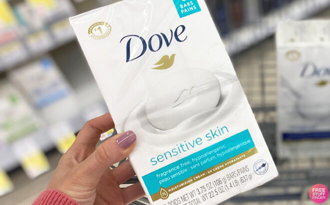 Woman holding a pack of Dove Beauty Bar Sensitive Skin