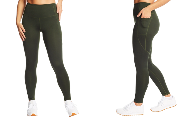 A Woman is Wearing Champion High Waisted Leggings in Bottle Green color