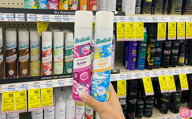 A hand holding Two Batiste Dry Shampoo