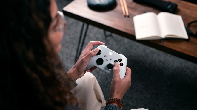 A lady using Xbox Core Wireless Controller in robot white color