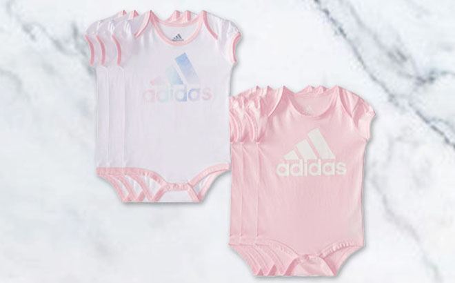 Adidas Baby Bodysuits on a Marbled Table