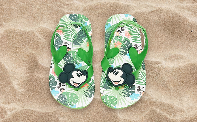 Disney Mickey Mouse Flip Flops in Green color on a beach sand