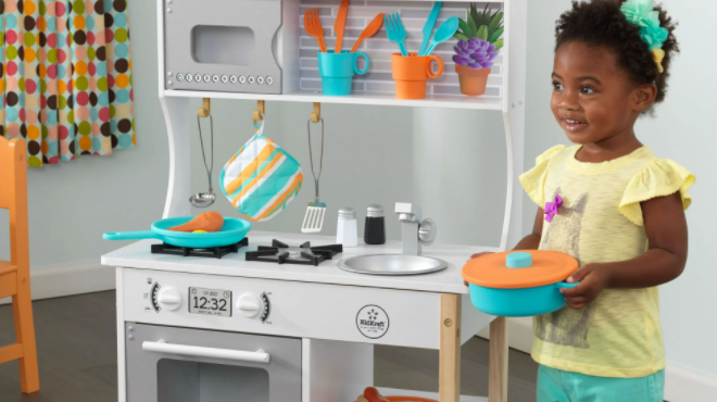 Girl Playing with KidKraft All Time Wooden Play Kitchen