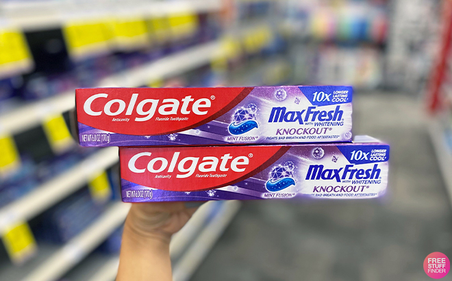 Hand Holding Colgate Max Fresh Knockout Toothpaste at CVS