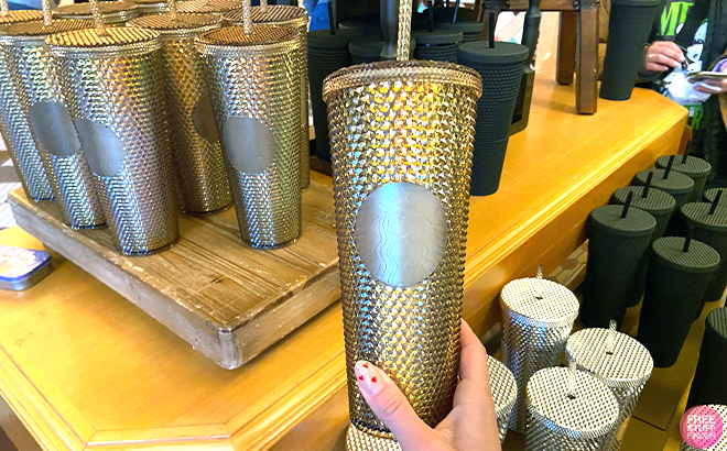 Hand Holding Disney Starbucks Disneyland Geometric Tumbler with Straw in Gold
