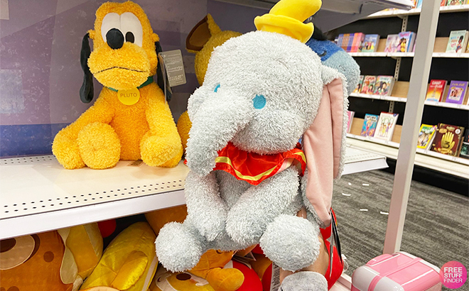 Hand Holding Dumbo Disney Weighted Plushies at Target
