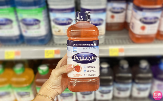 Hand Holding Pedialyte Electrolyte Drink 1L in Strawberry Flavor