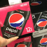 Hand Holding Pepsi Zero Soda Cans 12 Pack