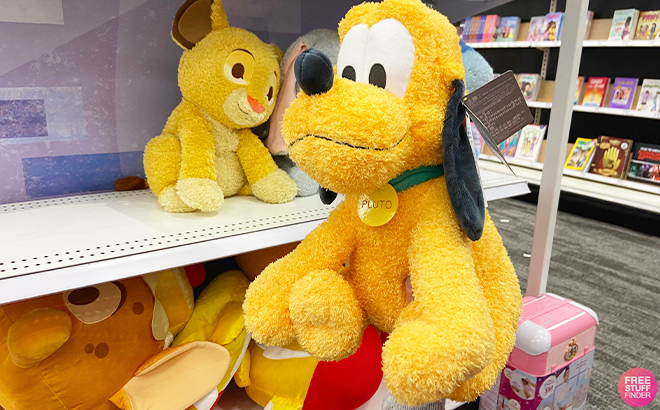 Hand Holding Pluto Disney Weighted Plushies at Target