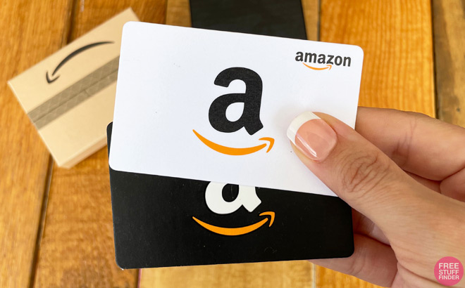 Hand Holding Two Amazon Gift Cards