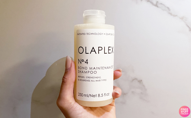 Hand Holding a Bottle of Olaplex No 4 Bond Maintenance Shampoo