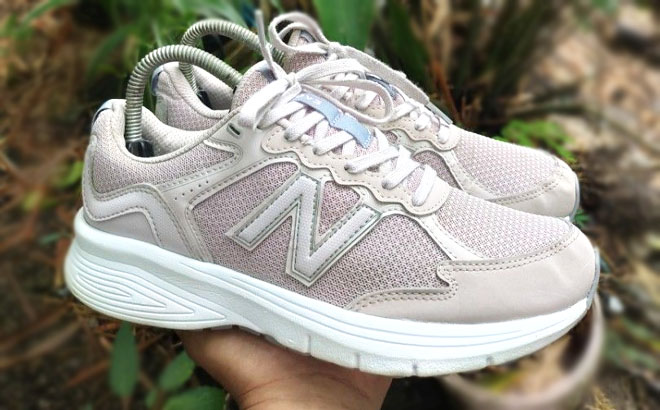 Hand Holding a New Balance Womens 460v3 Shoes