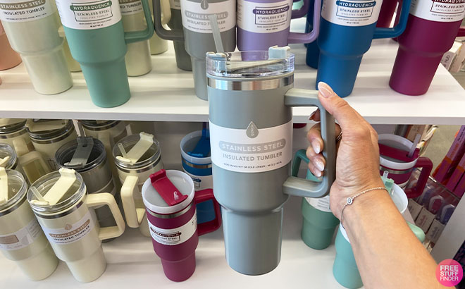 https://www.freestufffinder.com/wp-content/uploads/2023/08/Hand-Holding-a-Stainless-Steel-Insulated-Tumbler-in-Gray-Color.jpg