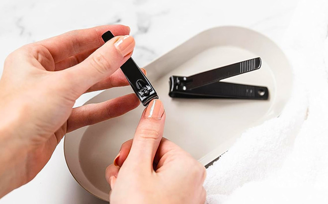 Hand holding Amazon Basics Nail Clippers 2 Pack Hand holding Amazon Basics Nail Clippers 2 Pack