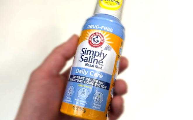 Hand holding Arm and Hammer Simply Saline Nasal Mist Hand holding Arm and Hammer Simply Saline Nasal Mist