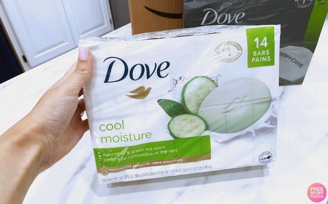 Hand holding Dove Cool Moisture Beauty Bar Soap Cucumber and Green Tea 14 Pack